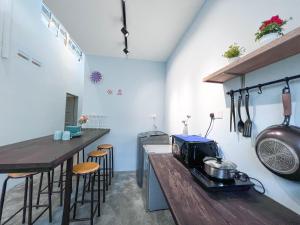 a kitchen with a counter with a toaster on a table at HUKM CoLiving 21 by Manhattan Group in Kuala Lumpur