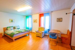 sypialnia z łóżkiem i krzesłem w obiekcie Residence Villa Flora w mieście Interlaken
