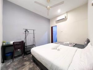 a bedroom with a bed and a desk and a chair at HUKM CoLiving 21 by Manhattan Group in Kuala Lumpur