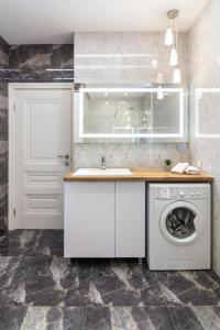 a kitchen with a sink and a washing machine at Royal 2 apartments on Shevchenka str in Lviv