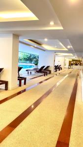 a room with tables and benches in a building at Sukhumvit13 Luxury suite in Bangkok