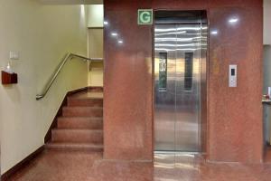 an elevator in a building with a stair case at Comfort Park Inn (Unit of Prohotel) in Chennai