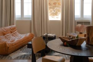 a living room with a couch and a table at MiHotel Serlin in Lyon