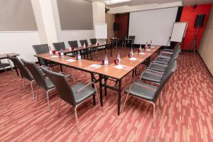 a conference room with a long table and chairs at Galleria Sukhumvit 10 Bangkok by Compass Hospitality in Bangkok