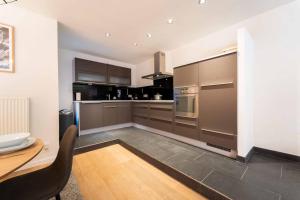a kitchen with stainless steel appliances and a table at Luxury Duplex Coeur de Mons 64-3 in Mons