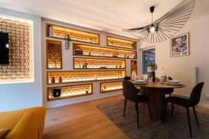 a dining room with a table and a wall of wine bottles at Luxury Duplex Coeur de Mons 64-3 in Mons