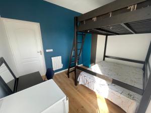 a bedroom with two bunk beds and a white door at Rooftop vue sur le Stade de France in Saint-Denis