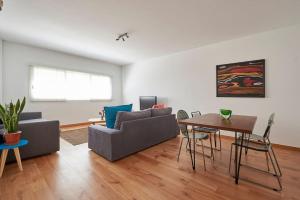 a living room with a couch and a table at Modern apartment in Parque das Nações in Lisbon