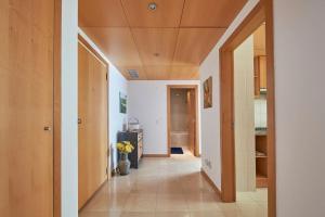 a hallway of a house with a vase of flowers at Modern apartment in Parque das Nações in Lisbon