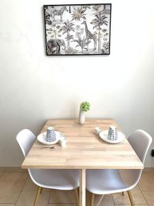 una mesa de madera con sillas y una foto en la pared en Le Maillon - Bourg-de-Péage, en Bourg-de-Péage