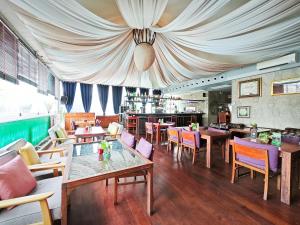 a dining room with tables and chairs in a restaurant at Galleria Sukhumvit 10 Bangkok by Compass Hospitality in Bangkok