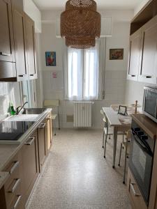 a kitchen with a sink and a table and a window at Casa Manolo Cesano Suite Apartment Milan in Cesano Boscone