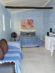 a bedroom with two beds and blue walls at BellaMaria in Pretoria