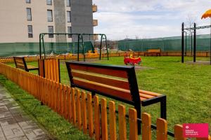 a park with a bench and a playground at Studio no5 Green in Sighişoara