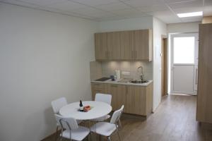 a kitchen with a table and chairs in a room at AK Apartments in Akureyri