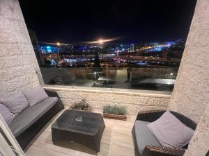 a balcony with a view of a city at night at Prime apartment with amazing view in Amman in Amman