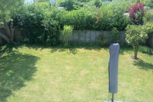 a yard with a sculpture in the grass at Zeewind II 112 in Bredene +1 photo