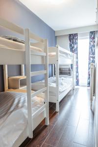 a room with three bunk beds in a room at Lilyta B303 in De Haan