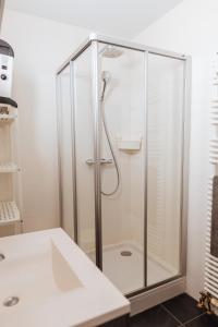 a shower with a glass enclosure in a bathroom at Lilyta B303 in De Haan