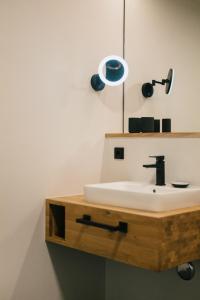 a bathroom with a sink and a mirror at CELLA Apartments **** in Zell im Wiesental