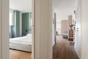 a bedroom with a bed and a room with green walls at Vatican Family Loft in Rome