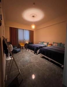 a hotel room with two beds and a table at Jing Cheng Homestay in Jincheng