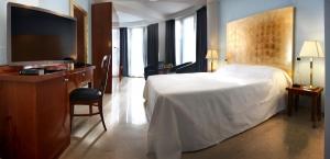 a hotel room with a bed and a flat screen tv at Hotel Terme Marine Leopoldo II TERME & SPA in Marina di Grosseto