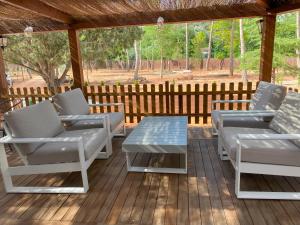 a deck with lounge chairs and a table at VILLAS LAS LAGUNAS 1 in Ossa de Montiel