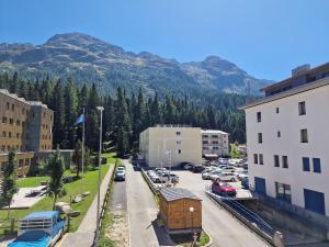 a view of a city with cars parked in a parking lot at Apartment Via Surpunt - Anda in St. Moritz