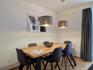 a dining room with a wooden table and chairs at Apartment Via Surpunt - Anda in St. Moritz