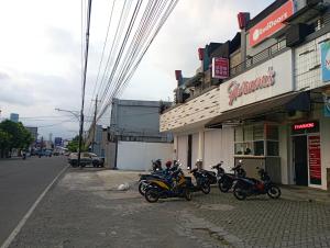 a group of motorcycles parked outside of a store at RedDoorz at Jalan Sudirman Purwokerto in Purwokerto