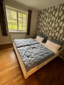 a bedroom with a large bed with a headboard at Meerlust Spiekeroog in Spiekeroog