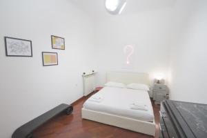 a bedroom with a white bed in a room at Bright home in Milan