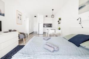 a white bedroom with a bed with two pillows on it at Modern Riverside Apartment with Free Parking in Budapest