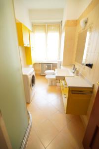 a bathroom with two sinks and a washing machine at Dolce Vita, garden, free parking in Turin