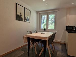 uma sala de jantar com uma mesa de madeira e cadeiras em Apartment Via Surpunt - Perspektiva - 5 Rooms em St. Moritz