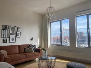 a living room with a couch and a large window at BizStay Harbour III Scheveningen Apartments in Scheveningen