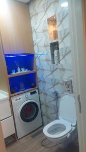 a bathroom with a toilet and a washing machine at Taghazout "luxe residence Tafoult" 3 pools and aquapark in Taghazout