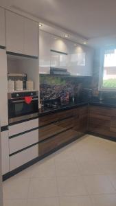 a kitchen with wooden cabinets and a stove top oven at Taghazout "luxe residence Tafoult" 3 pools and aquapark in Taghazout +37 photos