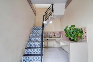 a staircase in a room with blue and white tiles at OYO 92861 Raya Guest House Syariah in Pekanbaru