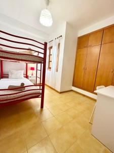 a bedroom with a bunk bed and a tiled floor at Lima Limon by Lovely property in Cotillo