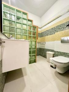 a bathroom with a toilet and a sink at Lima Limon by Lovely property in Cotillo