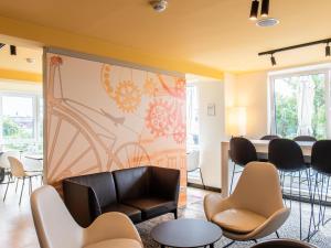 a waiting room with a large mural on the wall at B&B Hotel Schweinfurt-Süd in Schweinfurt