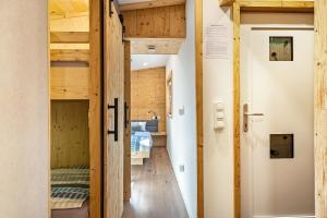 a tiny house with a hallway leading to a bedroom at Alpenchalet zum Hirsch in Aschau