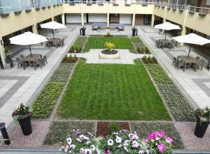 a courtyard with tables and umbrellas in a building at Studio Abee in Middelkerke