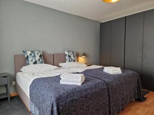 a bedroom with a bed with towels on it at Apartment Via Surpunt - Bella - 3 Rooms in St. Moritz