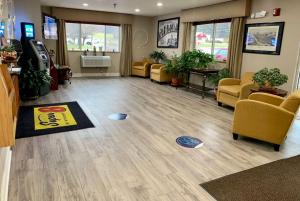 an empty waiting room with chairs and a waiting room at Super 8 by Wyndham Clearfield in Clearfield