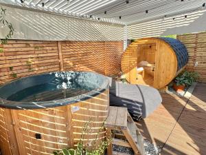 a hot tub and a sauna in a garden at Tiny House Gänseblümchen in Kirchanschöring