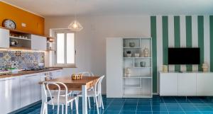 a kitchen with a table and chairs and a tv at Magarella in Villammare