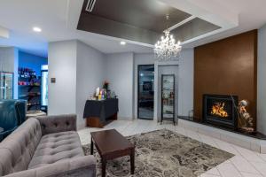 a living room with a couch and a fireplace at Baymont by Wyndham Rapid City in Rapid City